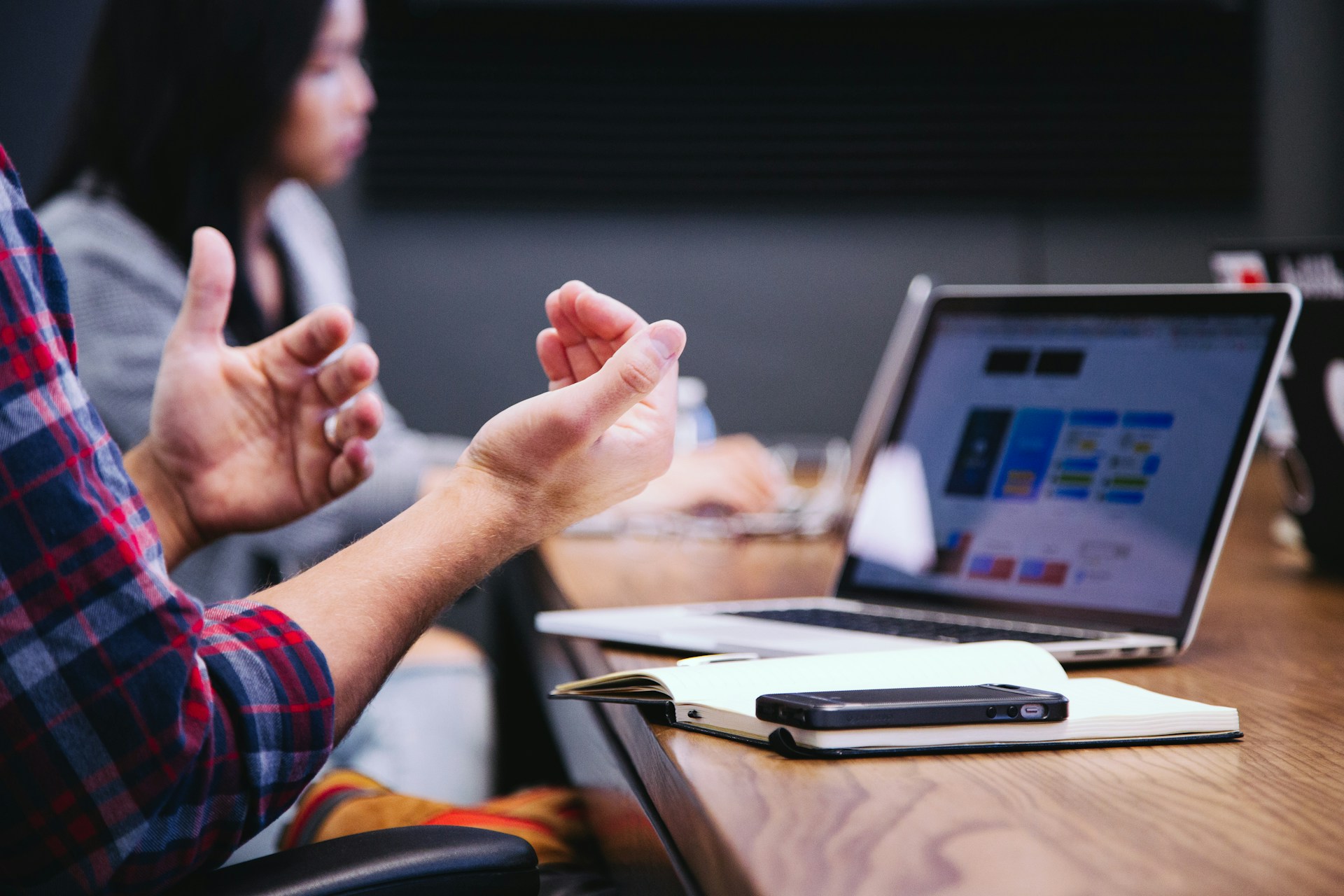 Team leader handing off task during workflow meeting